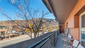 A balcony with a view of a street and hills. - North Of Nell, Unit 2m (Aspen)