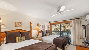 A hotel room with two beds, a ceiling fan, a balcony with a view, and a TV. - North Of Nell, Unit 3i (Aspen)