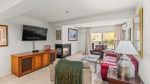 A living room with a fireplace, a television, a sofa, and a coffee table.