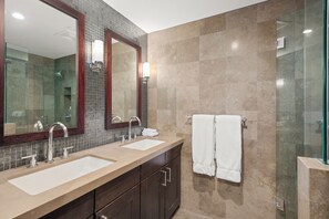 A modern bathroom with two sinks, a large mirror, and a glass shower enclosure. - North Of Nell, Unit 4e (Aspen)