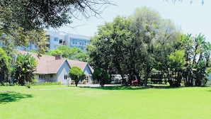 Un barrio residencial con una casa, césped y árboles.