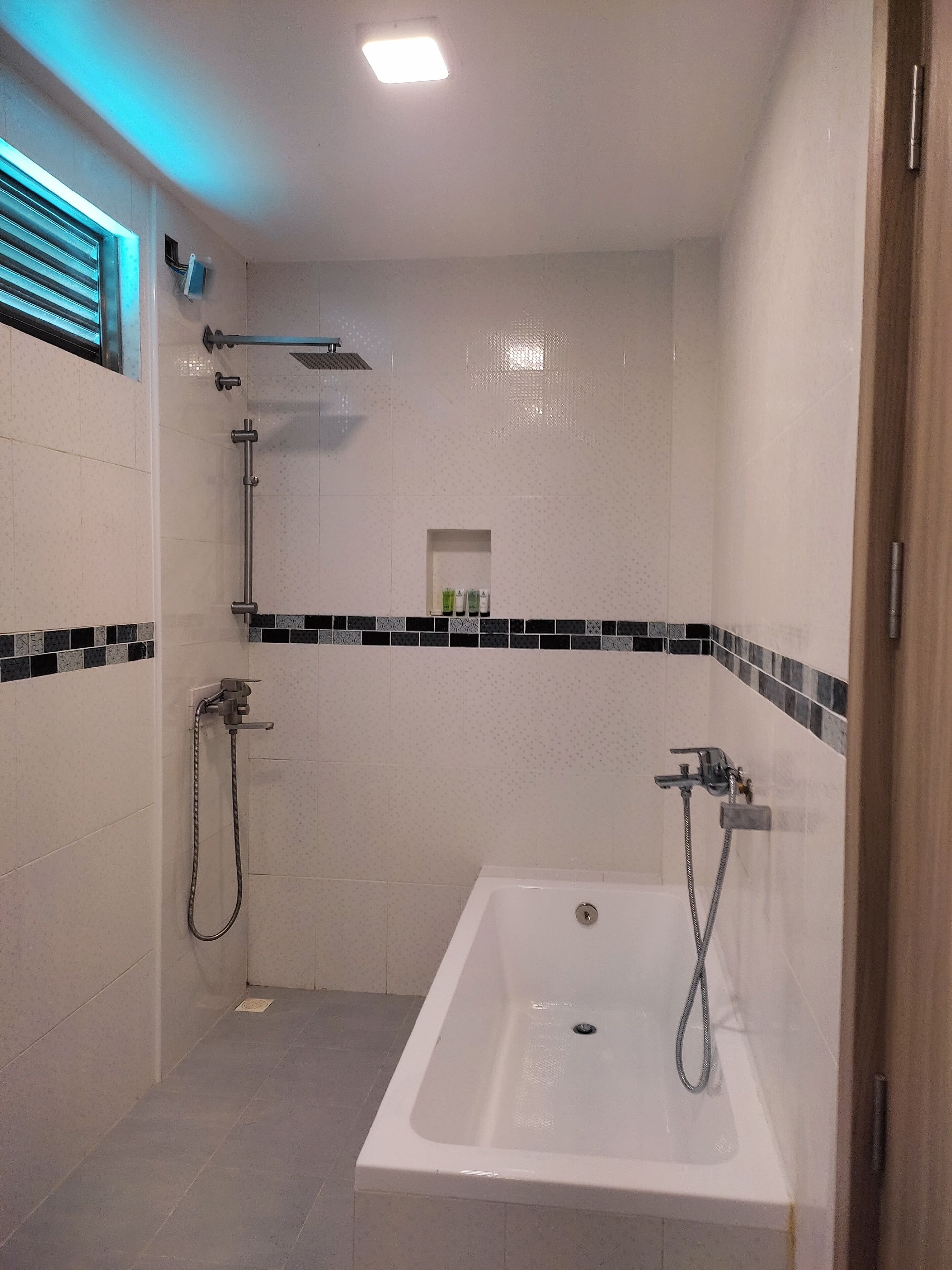 Un baño moderno con bañera, ducha y ducha de mano.