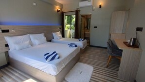 A hotel room with two beds, a desk, a chair, and a view of the outdoors. - Madi Grand Maldives  (Fulidhoo)