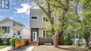 A two-story residential building with a stone facade and a wooden deck. - Confortable brand-new 1-bedroom close to downtown
(Saskatoon)