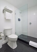 Shower, designer toiletries, hair dryer, slippers