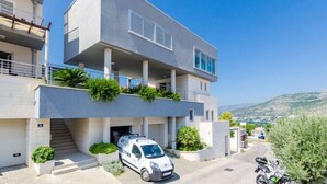 A modern two-story building with a car parked in front. - Villa Diana: Bayside View Beauty - a romantic home
 (Dubrovnik)