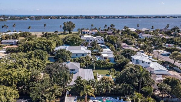A coastal residential area with houses, a swimming pool, and a view of the ocean.