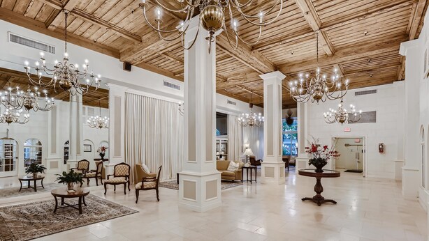 A spacious lobby with high ceilings, chandeliers, and a polished floor. - Palm Beach Hotel (Palm Beach)