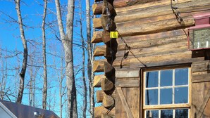 A stainless steel outdoor kitchen with a stone wall and a window. - Cabin on Pond and Vineyard next to Aging Cave (Chapel Hill)