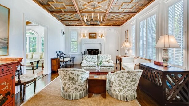 A spacious living room with a high ceiling, a fireplace, and a large window with blinds. - Villa Blanca 4bd 3.5ba Private Pool and Parking (West Palm Beach)
