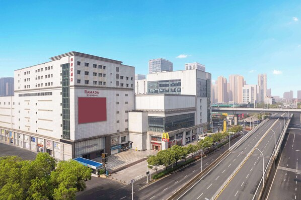 A modern building with a large glass facade, a prominent red sign, and a McDonald's logo.