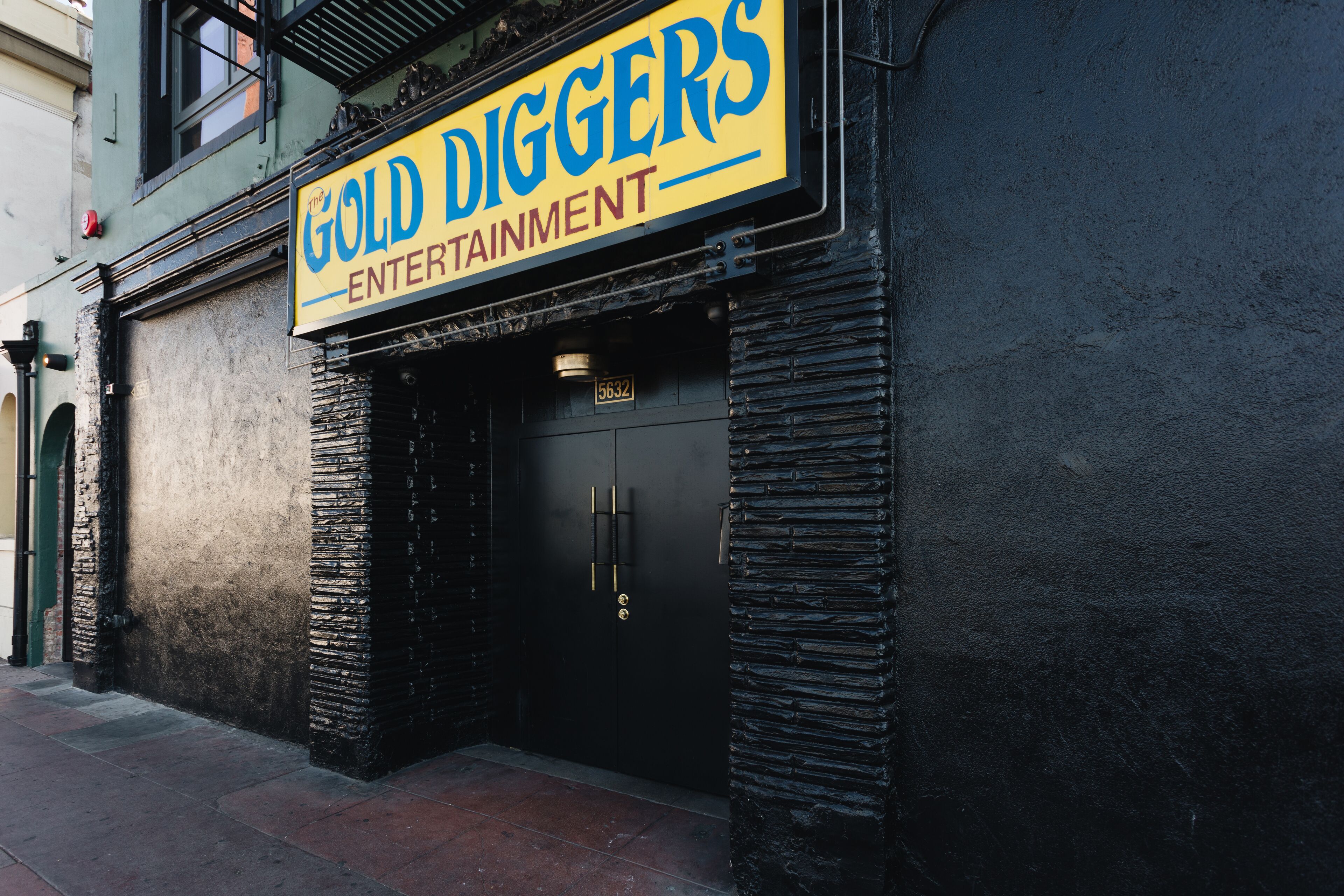 A building with a sign reading "The Gold Diggers Entertainment."