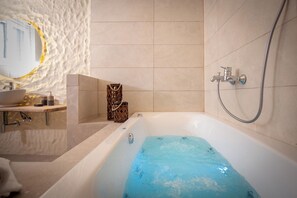 A bathroom with a bathtub, a sink, and a shower.