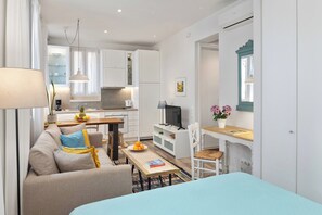 A modern apartment with a living area, kitchen, and dining space.