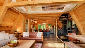 A spacious wooden interior with a living area, kitchen, and staircase. - Tranquil retreat nestled in the breathtaking landscape of Hocking Hills. (McArthur)