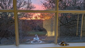 A view through a window with a stone fountain in the foreground and trees in the background. - Beautiful and Scenic 6 bedrooms and 6 bathrooms large pool a hot tub 7000sqft (Prospect)