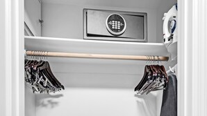 A walk-in closet with a shoe rack, a drying rack, and a storage unit with a lock. - Junior Suite Ocean View Floor Fontainebleau (Miami Beach)