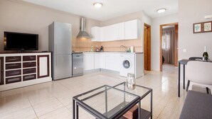 A modern kitchen with a built-in dishwasher, a stainless steel refrigerator, and a washing machine. - Vacation Apartment 'Casa Weimar' with Private Terrace and Wi-Fi (Costa Calma)
