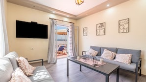 A modern living room with a sofa, coffee table, and artwork on the walls.