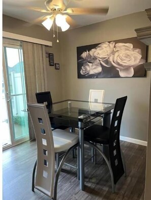 Enjoy meals in this stylish dining area with a glass-top table and comfortable seating for four.
