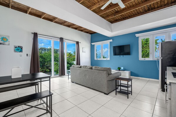 Comfort Apartment, 3 Bedrooms | Living area | 49-inch TV with digital channels, books - Villa Playa by Otium (San Juan)