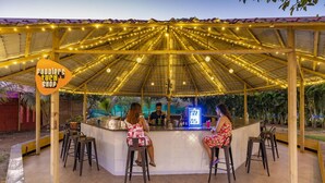 A covered outdoor bar area with a sign reading "Pobble's Tuch Shop". - Zostel Kolad (Roha)