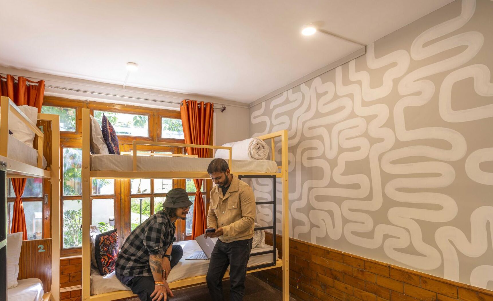 A bunk bed room with wooden walls and a patterned wall design.