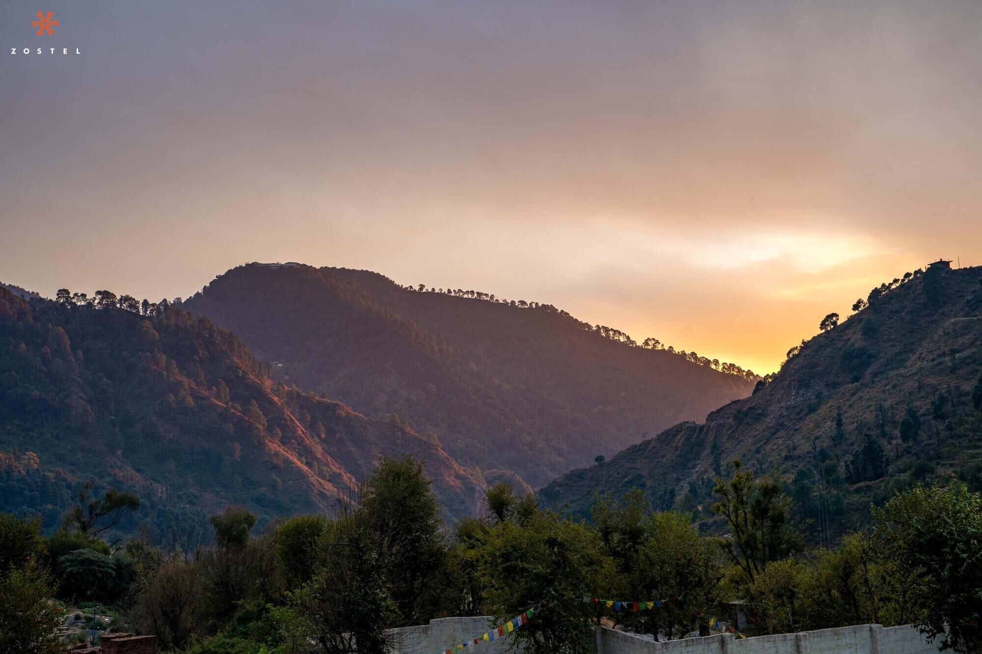 A mountainous landscape with a sunset.