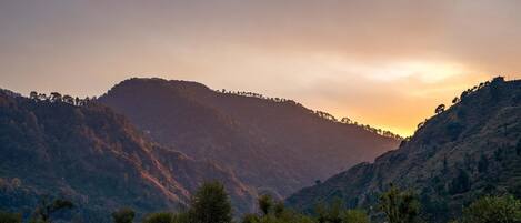 A mountainous landscape with a sunset.