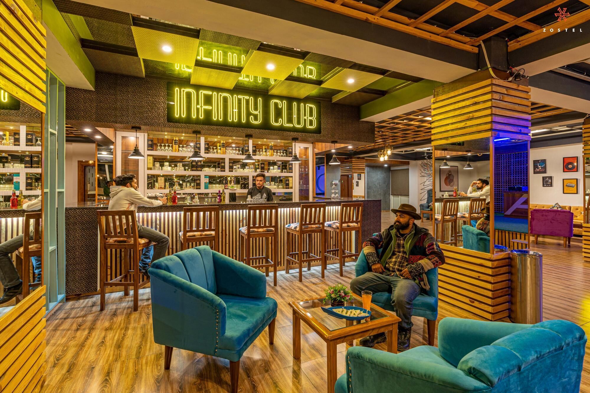 A bar area with neon signage, wooden furniture, and a bar counter.