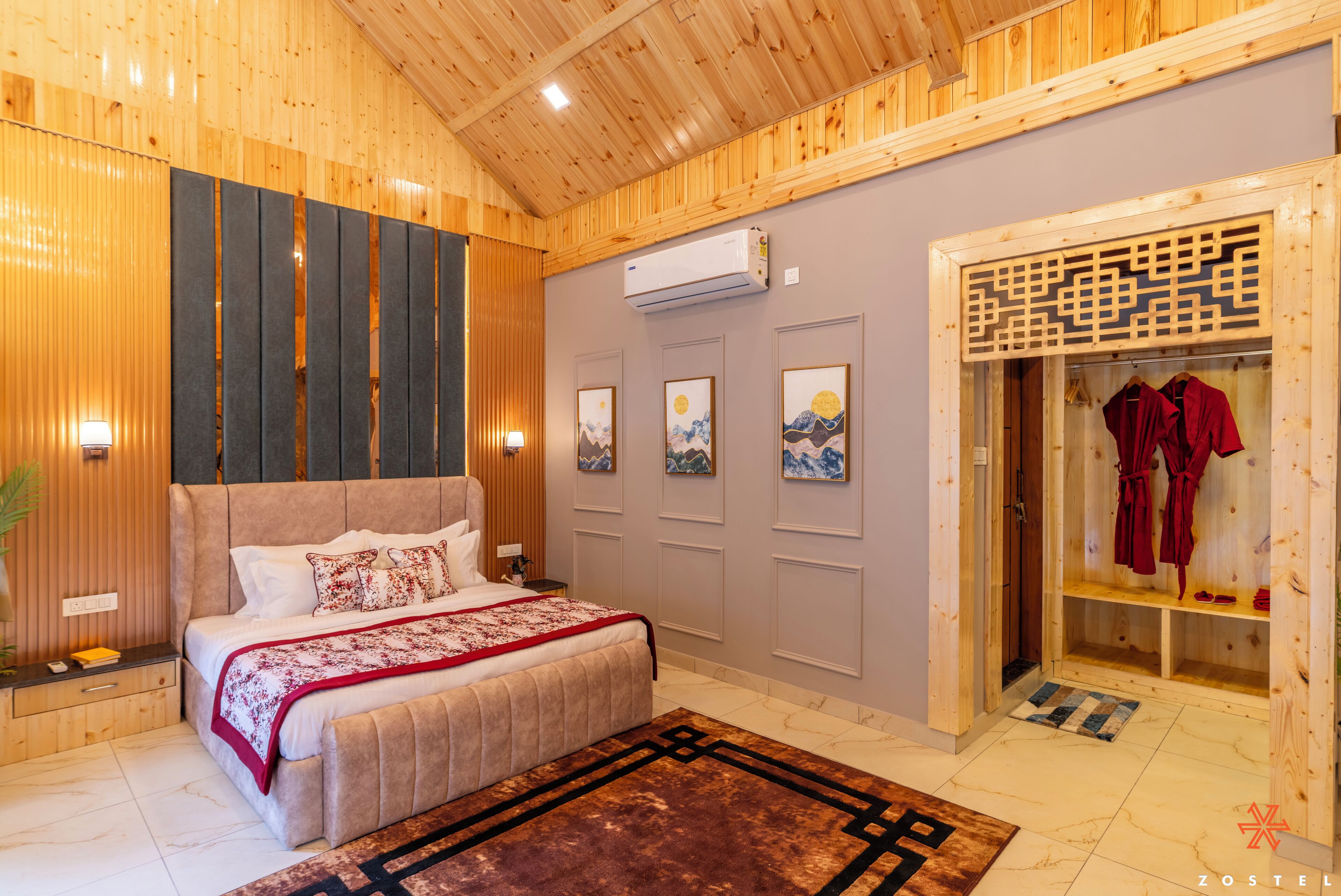 A bedroom with a large bed, wooden panel walls, a wardrobe, and a bathroom with a shower and towel rack.
