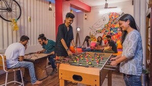 A room with a foosball table, a bicycle, and a mural on the wall. - Zostel Jodhpur - Clock Tower (Jodhpur)