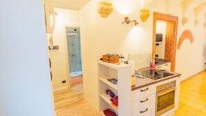 A modern bathroom with a shower, a vanity with a mirror, and a built-in oven.