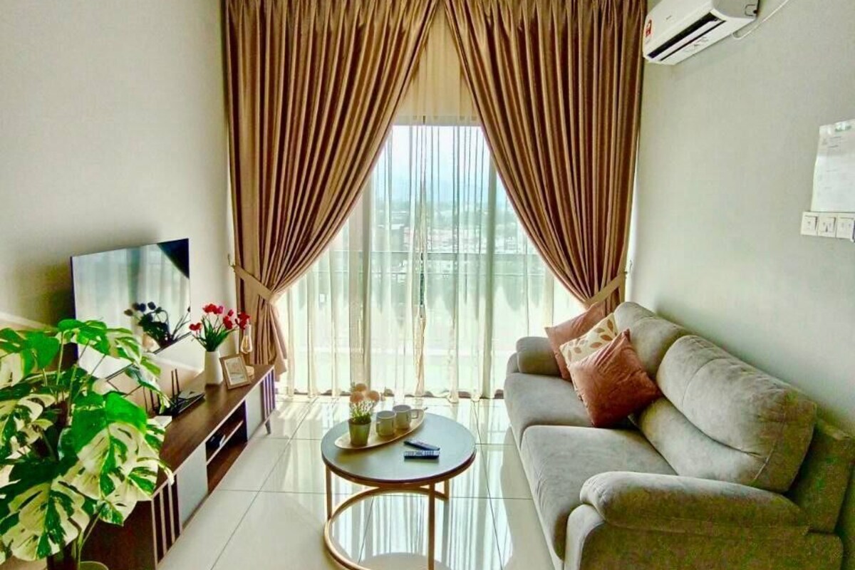 A living room with a ceiling fan, a sofa, a coffee table, a TV, and curtains.