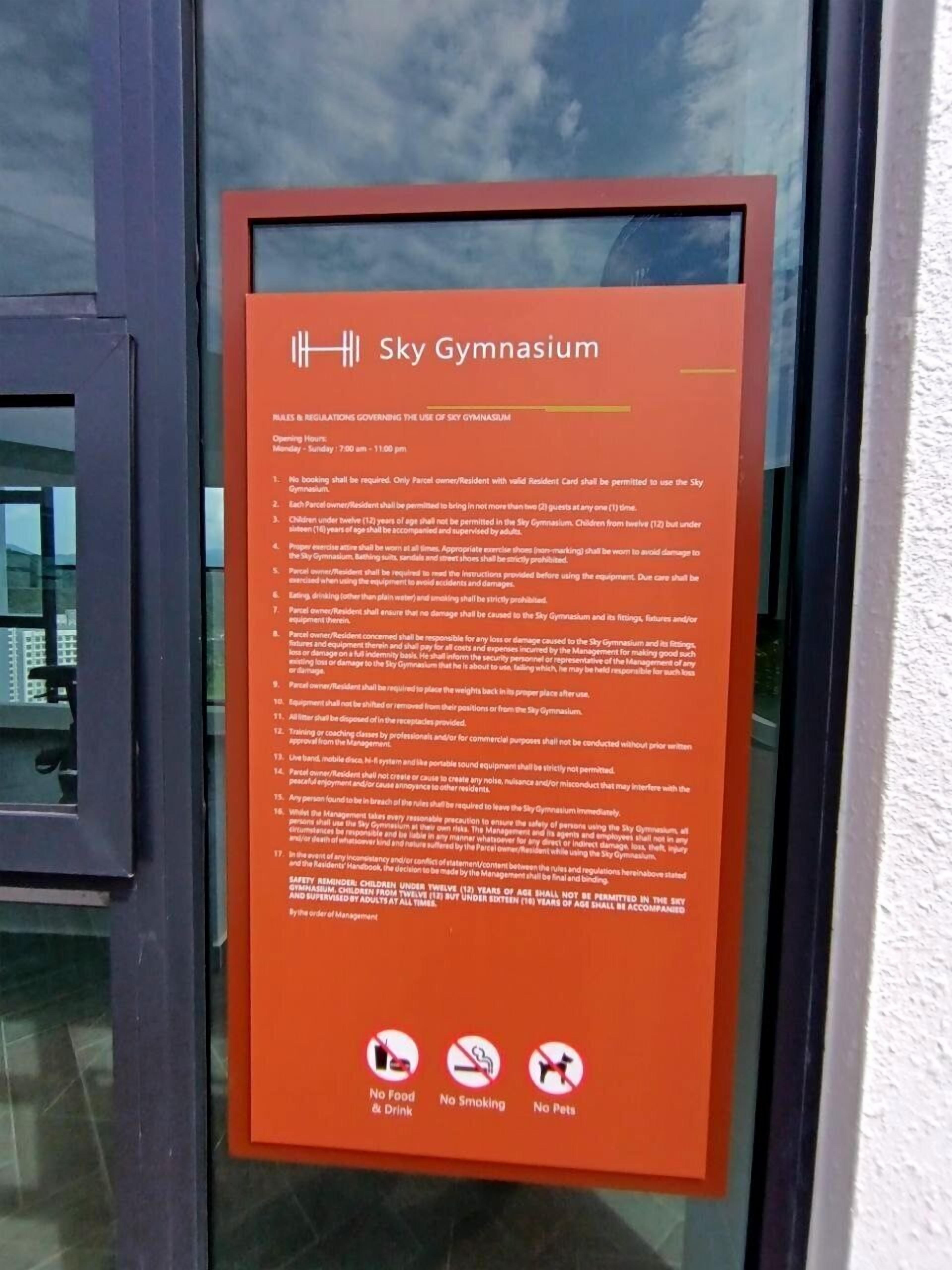 A sign detailing the rules and regulations for using the Sky Gymnasium, including opening hours and restrictions on food, smoking, and pets.