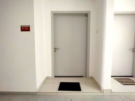 A hallway with two doors, one labeled "19-13A".