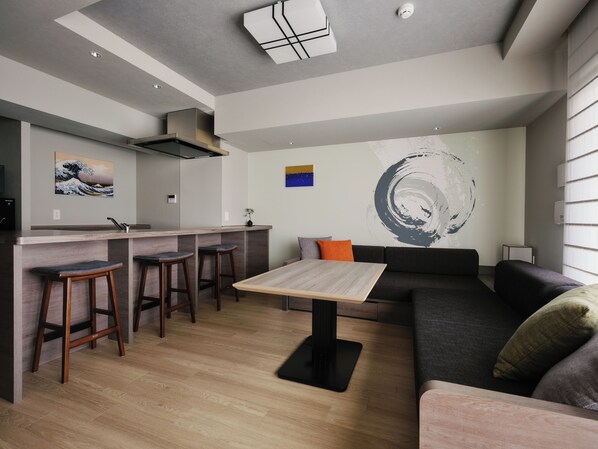 A modern living space with a kitchen, dining area, and seating. - GRAND MONday ASAKUSA(Former:MONday Apart Premium Asakusa) (Tokyo)