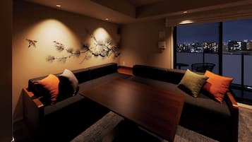 A modern living room with a sofa set, a coffee table, and a wall art piece.