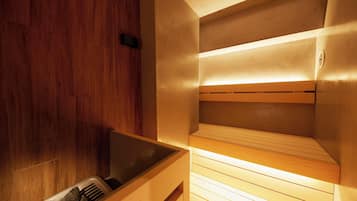 A sauna with wooden benches and a wooden wall.