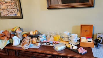 A breakfast buffet with various food items, including pastries, fruits, and beverages.