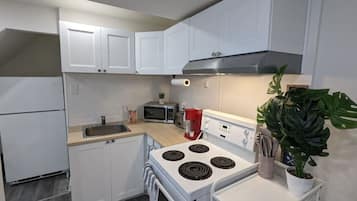 Fridge, microwave, coffee/tea maker, cookware/dishes/utensils