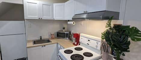 Fridge, microwave, coffee/tea maker, cookware/dishes/utensils