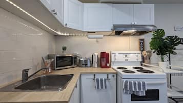 Fridge, microwave, coffee/tea maker, cookware/dishes/utensils