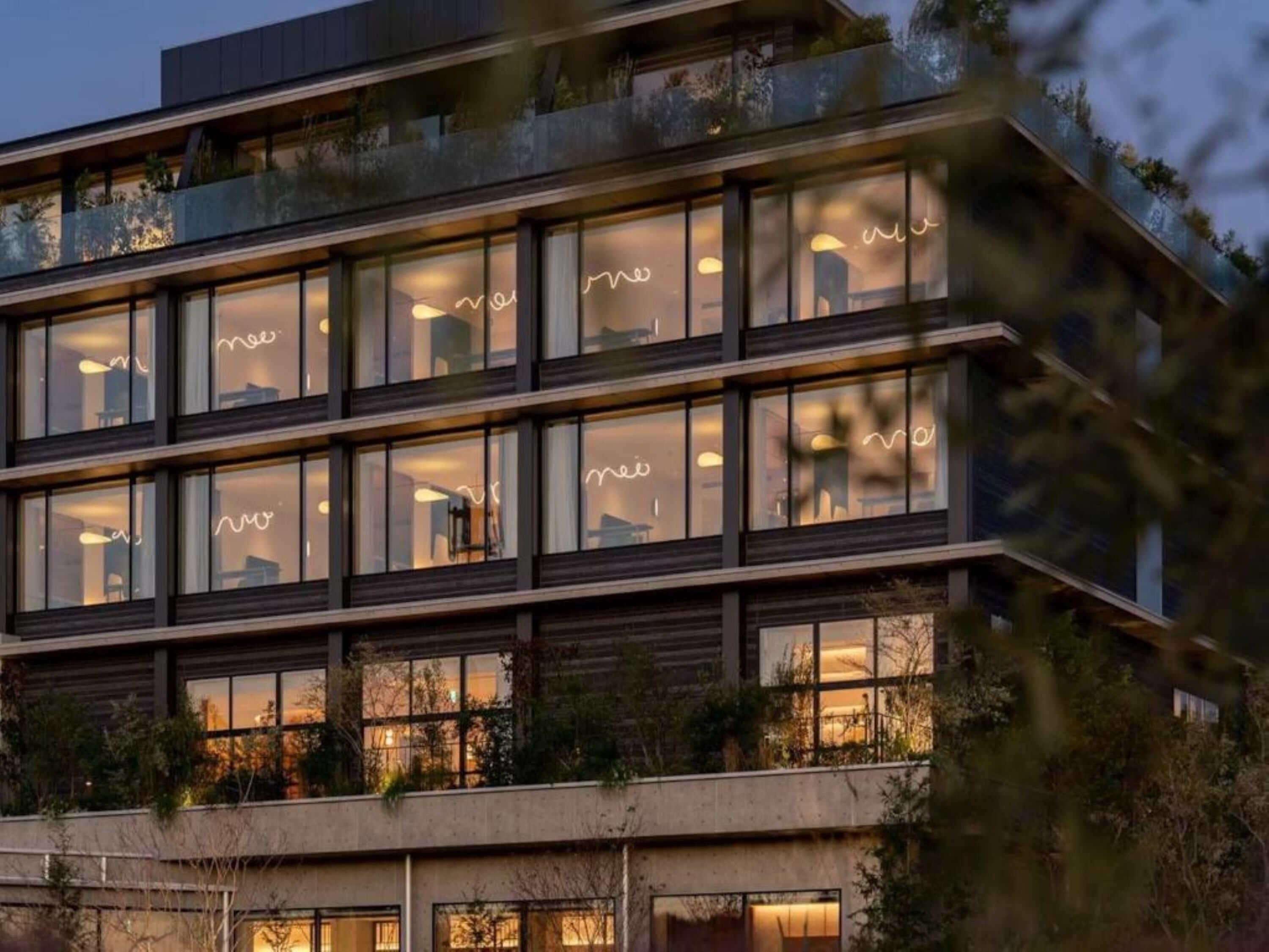 A multi-story building with large windows and balconies.