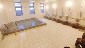 A large indoor swimming pool with a glass floor, multiple changing rooms, and a tiled floor. - kobe city shizennoie - Hostel (Kobe)