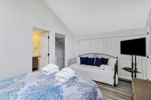 A bedroom with a bed, a television, and a wardrobe. - Walk to Beach & Golf | 2 BR Palmetto Dunes Villa (Hilton Head Island)