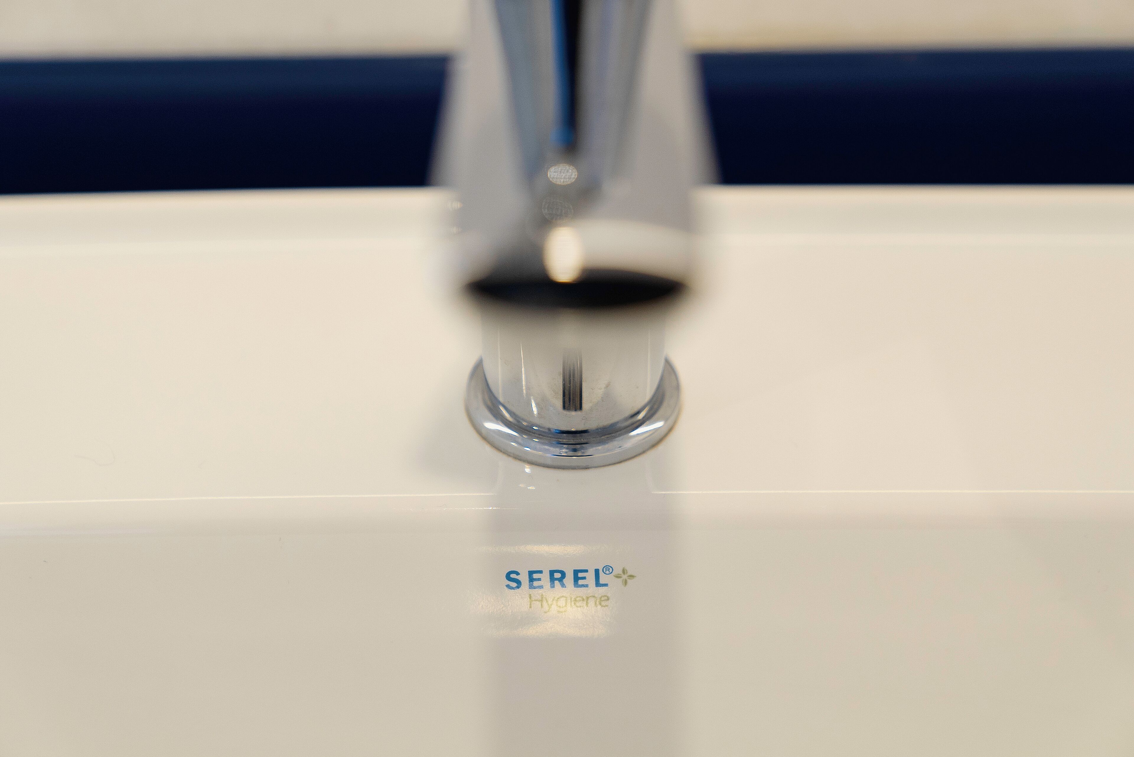A bathroom sink with a faucet and the brand name SEREL Hygiene visible on the surface.