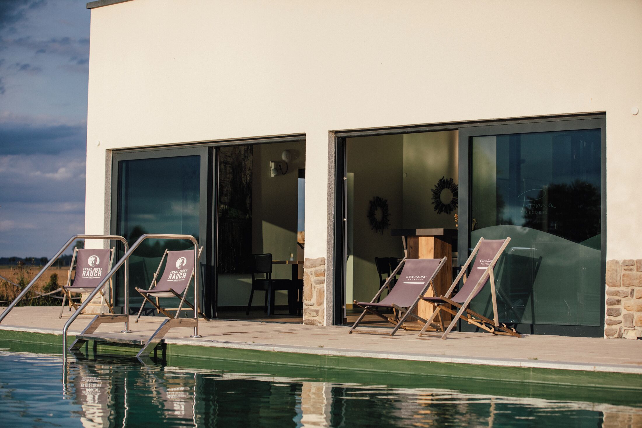 A poolside area with lounge chairs and a clear view of the pool.