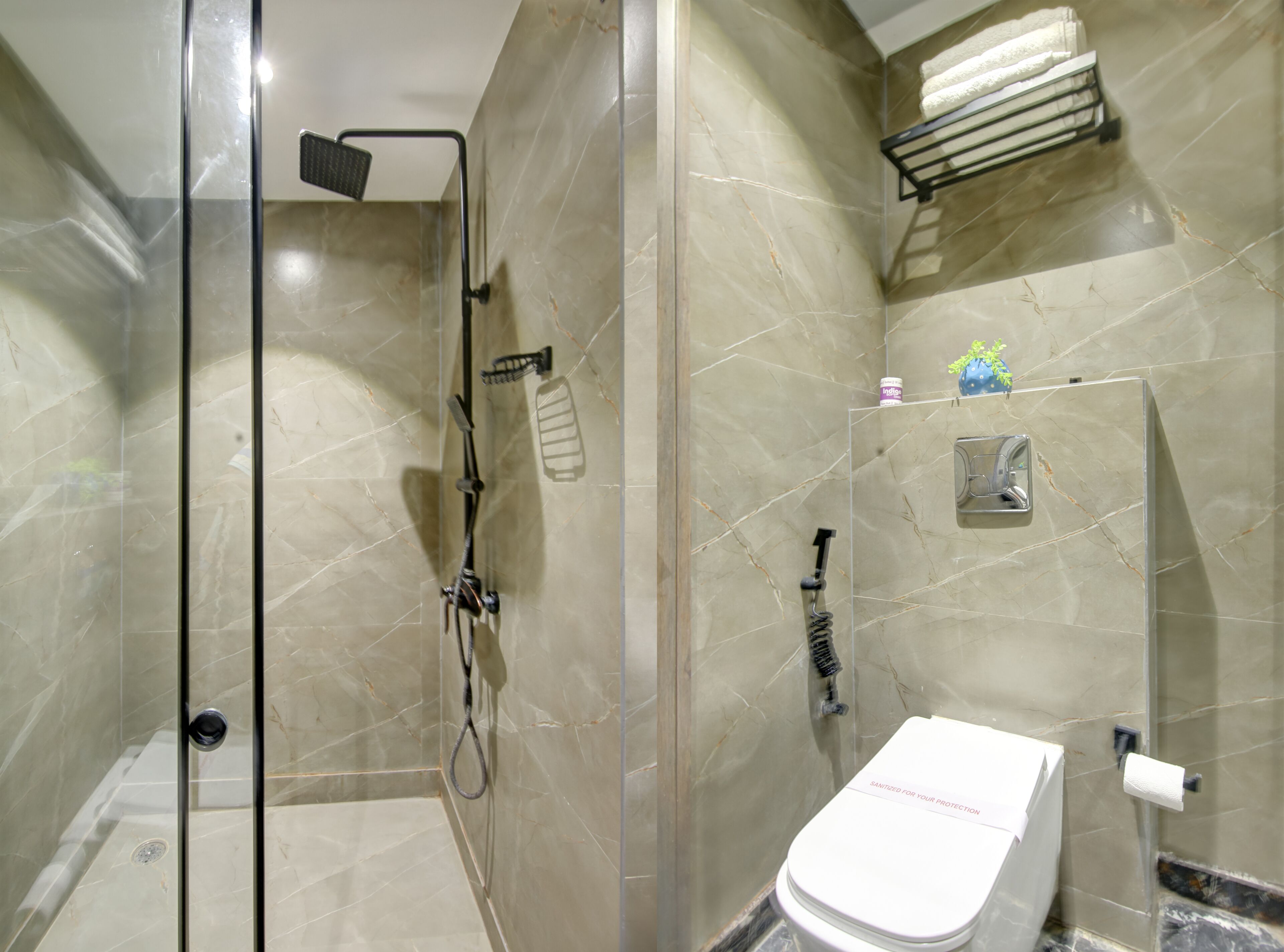 A modern bathroom with a glass-enclosed shower, a toilet, and a towel rack.