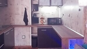 A compact kitchen with a microwave, a small refrigerator, and a sink. - 10 minutes walk to North Park, 5 minutes to Beli Dunav metro station.  (Sofia)